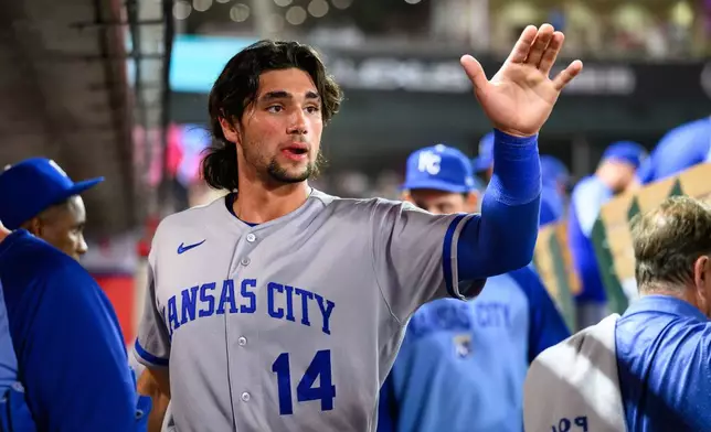 Kansas City Royals' Jac Caglianone is greeted by teammates after scoring during the seventh inning of a baseball game against the Los Angeles Angels, Friday, Aug. 14, 2026, in Anaheim, Calif. (AP Photo/William Liang)