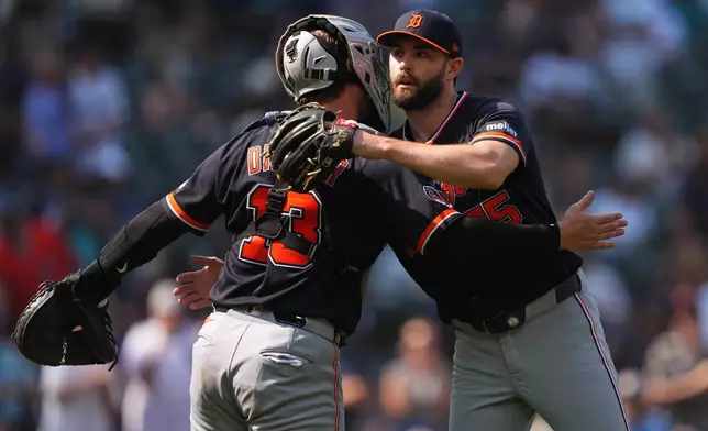 Detroit Tigers relief pitcher Brenan Hanifee, facing, greets catcher Dillon Dingler as they celebrate a win over the Seattle Mariners in a baseball game, Thursday, Aug. 6, 2026, in Seattle. (AP Photo/Lindsey Wasson)