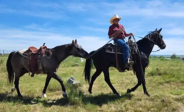 Patrick Carlow, Sr. leading a horse on Pine Ridge Reservation, S.D. on June 11, 2022. (Rhonda Akers via AP)