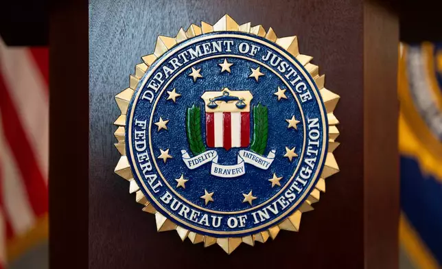 FILE - An FBI seal is displayed on a podium before a news conference at the field office in Portland, Ore., Jan. 16, 2025. (AP Photo/Jenny Kane, File)