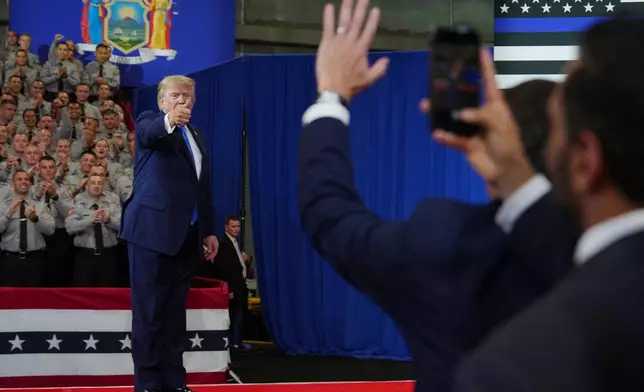 President Donald Trump departs as FBI Director Kash Patel, right, watches at the David Mack Center for Training and Intelligence, Friday, Aug. 14, 2026, in Garden City, N.Y. (AP Photo/Julia Demaree Nikhinson)