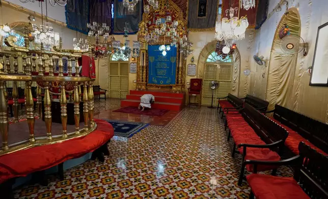 An Indian man prostrates himself in a traditional Hindu gesture of obeisance to the Torah ark during his visit to the 12th-century Kadavumbagam Synagogue in Ernakulam, mainland district of Kochi, India, Thursday, May 21, 2026. (AP Photo/Aijaz Rahi)