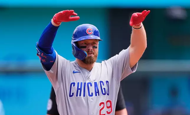 Chicago Cubs' Michael Busch celebrates on second after hitting a double during the first inning of a baseball game against the Kansas City Royals, Sunday, Aug. 9, 2026, in Kansas City, Mo. (AP Photo/Charlie Riedel)