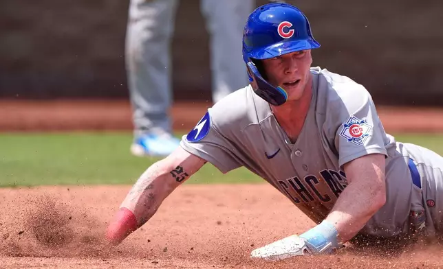 Chicago Cubs' Pete Crow-Armstrong slides home to score on a single by Alex Bregman during the fourth inning of a baseball game against the Kansas City Royals, Sunday, Aug. 9, 2026, in Kansas City, Mo. (AP Photo/Charlie Riedel)