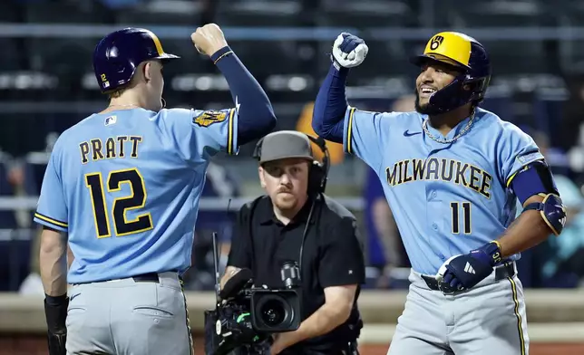 Milwaukee Brewers' Jackson Chourio, right, is congratulated by Cooper Pratt (12) after hitting a two-run home run during the eighth inning of a baseball game against the New York Mets Thursday, Aug. 27, 2026, in New York. (AP Photo/Adam Hunger)