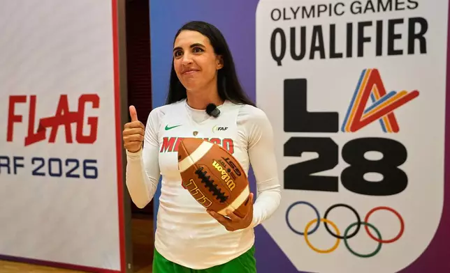 Silvia Contreras, captain of Mexico's women's team, holds a football during the media day ahead of the Flag Football World Championships, the sports first Olympic qualifier for LA28, in Duesseldorf, Germany, Wednesday, Aug. 12, 2026. (AP Photo/Martin Meissner)