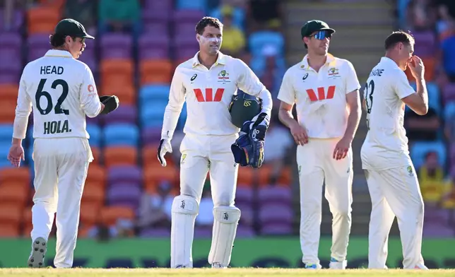 Australian players from left, Travis Head, Alex Carey, Pat Cummins and Marnus Labuschagne react at the close of play on day two of the first cricket test against Bangladesh in Darwin, Australia, Friday, Aug.14, 2026, (James Ross/AAPImage via AP)
