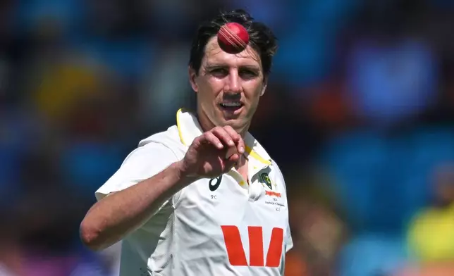 Australia's captain Pat Cummins prepares to catch the ball during play on day three of the first cricket test against Bangladesh in Darwin, Australia, Saturday, Aug.15, 2026, (James Ross/AAPImage via AP)