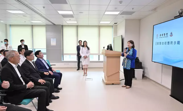 The Chief Executive, Mr John Lee (second left), earlier visited Kwong Wah Hospital to hear an introduction by the Chief Executive of the Hospital Authority, Dr Libby Lee (right), on the hospital's application of innovative technologies. Source: HKSAR Government Press Releases