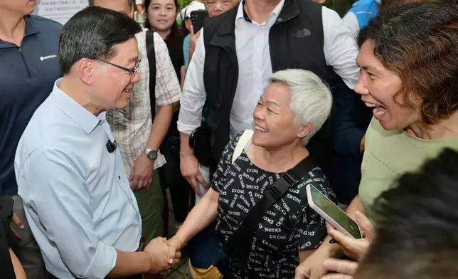 The Chief Executive, Mr John Lee, visited Sham Shui Po District today (August 26) to gather public views on Policy Address. Photo shows Mr Lee (first left) interacting with a member of the public at Un Chau Estate. Source: HKSAR Government Press Releases