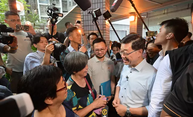 The Chief Executive, Mr John Lee, visited Sham Shui Po District today (August 26) to gather public views on Policy Address. Photo shows Mr Lee (second right) interacting with a member of the public at Un Chau Estate.Source: HKSAR Government Press Releases