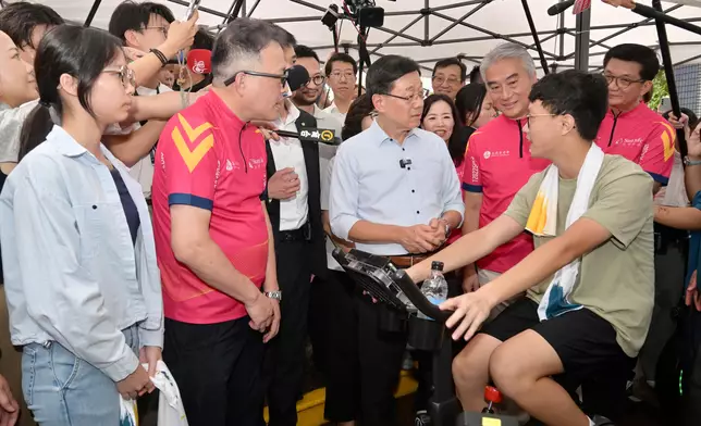 The Chief Executive, Mr John Lee, visited Sham Shui Po District today (August 26) to gather public views on Policy Address. Photo shows Mr Lee (third right) interacting with a member of the public at Un Chau Estate. Source: HKSAR Government Press Releases