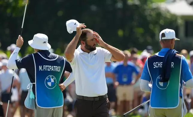 Scottie Scheffler walks off the 18th green during the second round of the BMW Championship golf tournament, Friday, Aug. 21, 2026, in St. Louis. (AP Photo/Jeff Roberson)