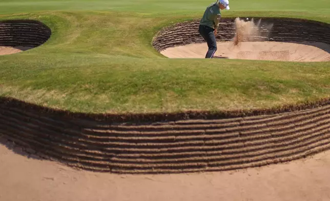 Charley Hull, of England, plays a shot out of a bunker on the 17th hole during the second round of the Women's British Open golf championship in Lytham St Annes, England, Friday, July 31, 2026. (AP Photo/Jon Super)