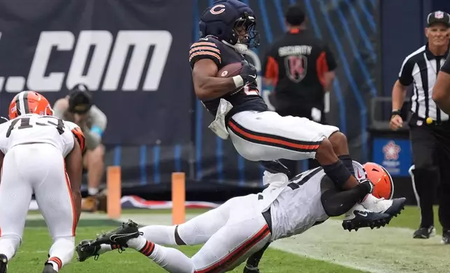 Cleveland Browns safety Christopher Edmonds (41) tackles Chicago Bears running back Roschon Johnson (23) during the first half of a preseason NFL football game, Saturday, Aug. 15, 2026, in Chicago. (AP Photo/David Banks)