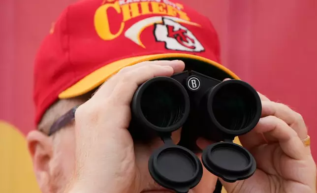 A fans watches during the Kansas City Chiefs' NFL football training camp Saturday, Aug. 1, 2026, in St. Joseph, Mo. (AP Photo/Charlie Riedel)