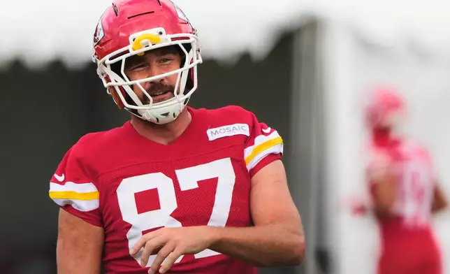 Kansas City Chiefs tight end Travis Kelce talks with a teammate during NFL football training camp Saturday, Aug. 1, 2026, in St. Joseph, Mo. (AP Photo/Charlie Riedel)