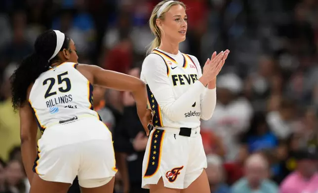 Indiana Fever's Sophie Cunningham claps as Chicago Sky's DiJonai Carrington is ejected from the game after committing a flagrant foul against her during the first half of an WNBA basketball game in Chicago, Saturday, Aug. 8, 2026. (AP Photo/Paul Beaty)