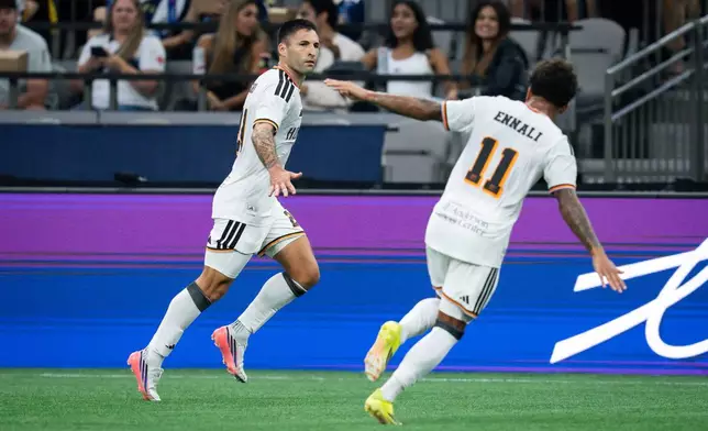 Houston Dynamo FC's Franco Negri, left, celebrates his goal against the Vancouver Whitecaps with Lawrence Ennali during the first half of an MLS soccer match in Vancouver, B.C., on Wednesday, Aug. 19, 2026. (Ethan Cairns/The Canadian Press via AP)