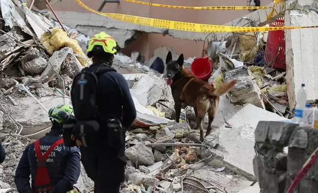 Firefighters search through rubble two days after an earthquake struck Cali, Colombia, Wednesday, Aug. 12, 2026. (AP Photo/Santiago Saldarriaga)