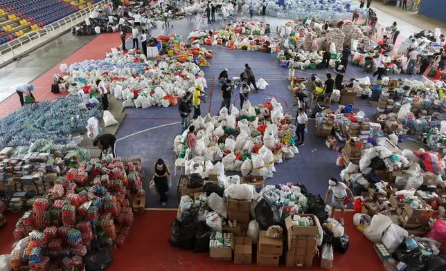 Volunteers sort aid for people affected by the earthquake in Cali, Colombia, Wednesday, Aug. 12, 2026. (AP Photo/Santiago Saldarriaga)