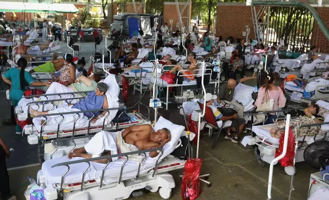 Patients from a clinic evacuated due to earthquake damage lie in beds at a temporary facility set up in a gymnasium at a nearby school in Cali, Colombia, Tuesday, Aug. 11, 2026. (AP Photo/Santiago Saldarriaga)