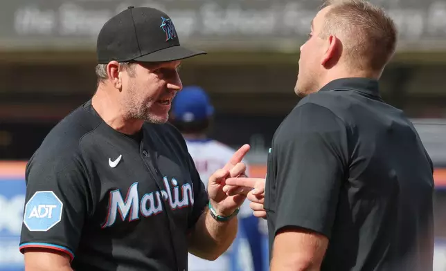 Miami Marlins manager Clayton McCullough, left, argues with home plate umpire Brock Ballou, right, during the second inning of a baseball game against the New York Mets, Saturday, Aug. 1, 2026, in New York. (AP Photo/Heather Khalifa)