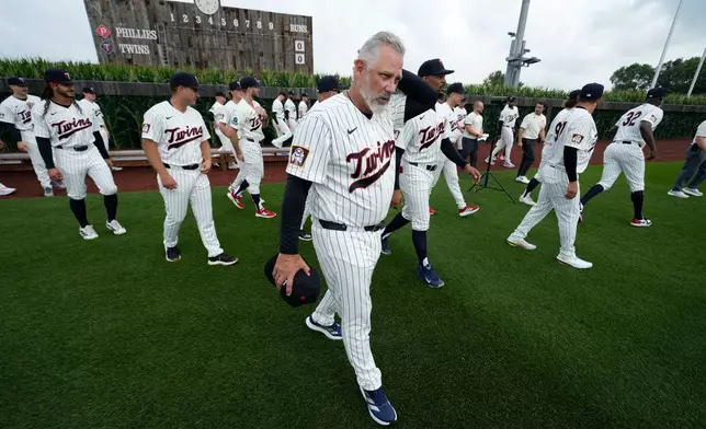 Minnesota Twins manager Derek Shelton walks off the field after a team photo before a baseball game against the Philadelphia Phillies at the Field of Dreams movie site, Thursday, Aug. 13, 2026, in Dyersville, Iowa. (AP Photo/Charlie Neibergall)