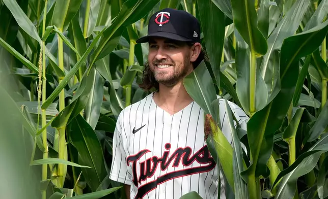 Minnesota Twins pitcher Dean Kremer poses for a photo in a cornfield before a baseball game against the Philadelphia Phillies at the Field of Dreams movie site, Thursday, Aug. 13, 2026, in Dyersville, Iowa. (AP Photo/Charlie Neibergall)