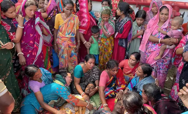 Relatives mourn over the bodies of victims of a suspected gas leak at a shipbreaking yard during the dismantling of a decommissioned ship in Sitakunda area of Chattogram, Bangladesh, Friday, Aug. 14, 2026. (AP Photo)
