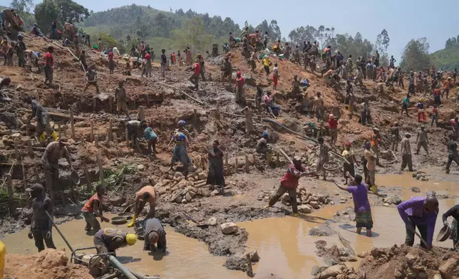 People search for gold at a mining site in Iga-Barrière, Ituri province, eastern Congo, Friday, Aug. 14, 2026. (AP Photo/Dieudonne Dirole)