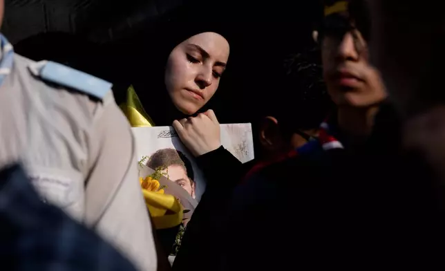 A woman mourns during the funeral of Hezbollah member Ali al-Haj Hassan, his wife and four children who were killed the previous day by an Israeli airstrike, in the southern suburb of Beirut, Lebanon, Sunday, Aug. 16, 2026. (AP Photo/Hussein Malla)
