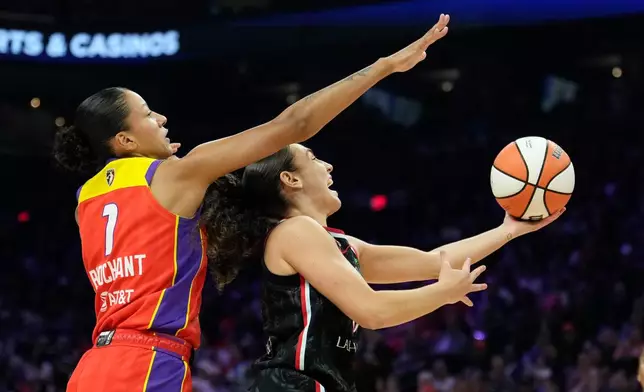 Portland Fire guard Carla Leite, right, drives past Phoenix Mercury forward Noemie Brochant (1) during the first half of a WNBA basketball game Sunday, Aug. 16, 2026, in Phoenix. (AP Photo/Ross D. Franklin)