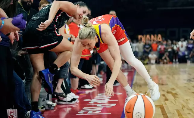 Phoenix Mercury guard Sami Whitcomb, right, and Portland Fire forward Bridget Carleton, left, collide as they try to get to the basketball during the first half of a WNBA basketball game Sunday, Aug. 16, 2026, in Phoenix. (AP Photo/Ross D. Franklin)
