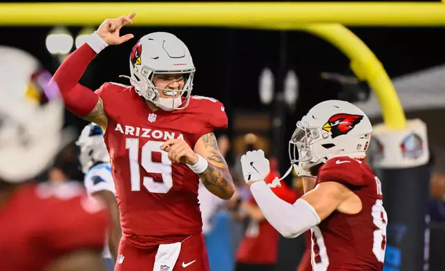 Arizona Cardinals quarterback Carson Beck (19) and wide receiver Simi Fehoko, right, celebrate after Beck threw a touchdown pass to Fehoko in the first half of the Pro Football Hall of Fame NFL preseason game in Canton, Ohio, Thursday, Aug. 6, 2026. (AP Photo/David Richard)