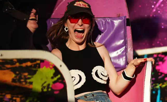 Lana Berge, of Minneapolis, screams while riding the Tilt-A-Whirl with friends Thursday, Aug. 27, 2026, at the Minnesota State Fair in Falcon Heights, Minn. (AP Photo/Ellen Schmidt)