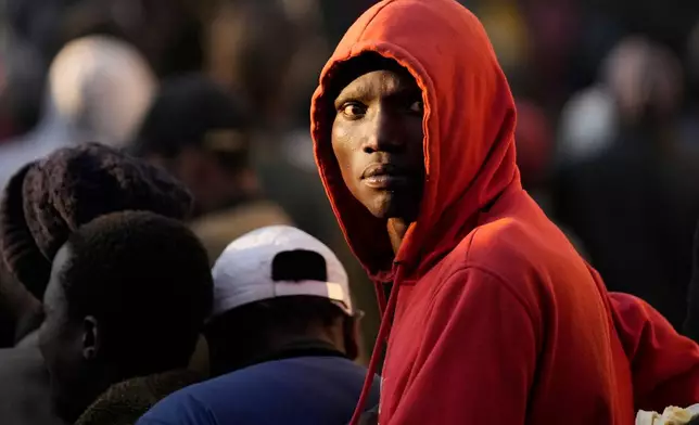 FILE - A Malawian migrant stands in a queue ahead deportation at a temporary centre in Durban, South Africa, Friday, June 19, 2026. (AP Photo/Themba Hadebe, file)
