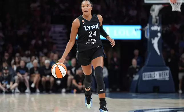 Minnesota Lynx forward Napheesa Collier dribbles down the court during the first half of a WNBA basketball game against the Las Vegas Aces in Minneapolis, Saturday, Aug. 8, 2026. (AP Photo/Abbie Parr)
