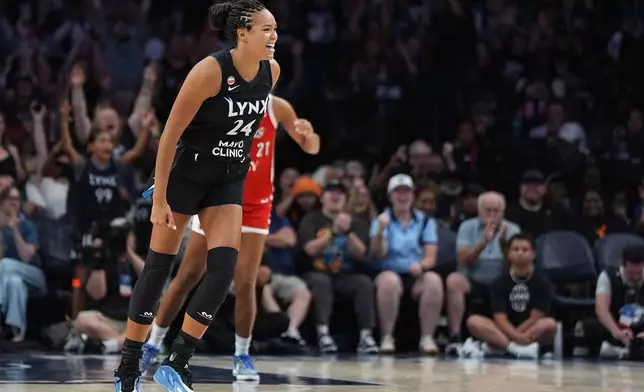 Minnesota Lynx forward Napheesa Collier (24) celebrates after making a 3-point shot during the second half of a WNBA basketball game against the Las Vegas Aces Saturday, Aug. 8, 2026, in Minneapolis. (AP Photo/Abbie Parr)