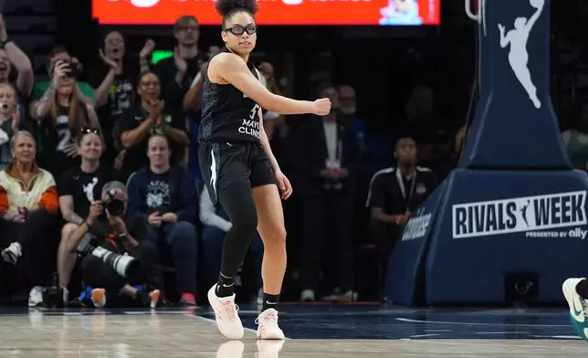 Minnesota Lynx guard Olivia Miles (5) celebrates after making a shot during the second half of a WNBA basketball game against the Las Vegas Aces Saturday, Aug. 8, 2026, in Minneapolis. (AP Photo/Abbie Parr)