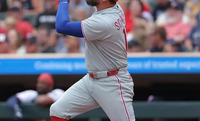 Philadelphia Phillies designated hitter Kyle Schwarber hits a double during the first inning of a baseball game against the Minnesota Twins, Sunday, Aug. 16, 2026, in Minneapolis. (AP Photo/Bailey Hillesheim)