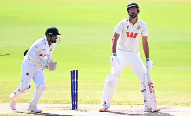 Beau Webster, right, of Australia reacts after being dismissed by Mehidy Hasan Miraz of Bangladesh during play on day four of the first cricket test in Darwin, Australia, Sunday, Aug. 16, 2026. (James Ross/AAP Image via AP)