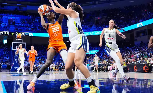 Connecticut Sun guard Saniya Rivers (22) works to take a shot as Dallas Wings' Maddy Siegrist, right, defends during the first half of a WNBA basketball game in Arlington, Texas, Sunday, Aug. 2, 2026. (AP Photo/Tony Gutierrez)