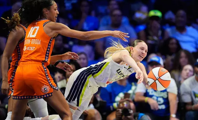 Dallas Wings guard Paige Bueckers, right, makes a pas as Connecticut Sun's Olivia Nelson-Ododa (10) defends during the first half of a WNBA basketball game in Arlington, Texas, Sunday, Aug. 2, 2026. (AP Photo/Tony Gutierrez)