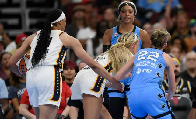 Chicago Sky's DiJonai Carrington, back, stares down Indiana Fever's Sophie Cunningham (8) after committing a flagrant foul against Cunningham and before she was ejected from the game during the first half of an WNBA basketball game in Chicago, Saturday, Aug. 8, 2026. (AP Photo/Paul Beaty)