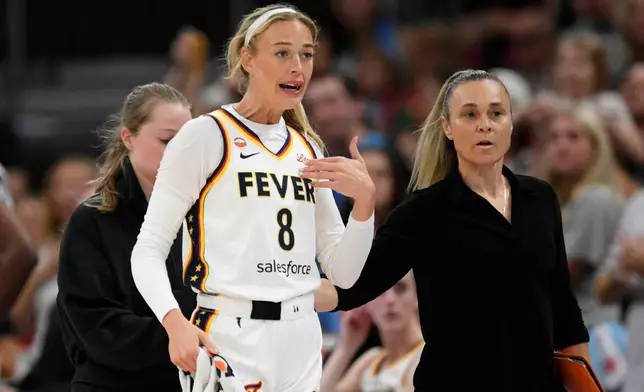 Indiana Fever's Sophie Cunningham (8) reacts while talking to the Chicago Sky bench after being fouled during the first half of an WNBA basketball game in Chicago, Saturday, Aug. 8, 2026. (AP Photo/Paul Beaty)