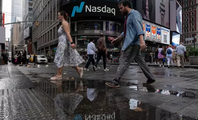 People walk past the Nasdaq MarketSite, Thursday, Aug. 6, 2026, in New York. (AP Photo/Yuki Iwamura)