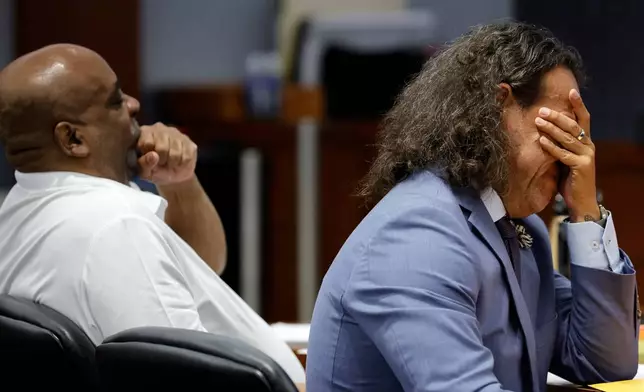 Michael Sanft, right, attorney for Duane Davis, rubs his face while sitting with Davis, left, during the third day of jury selection in Davis' murder trial, related to the 1996 killing of rapper Tupac Shakur, at Clark County District Court Regional Justice Center on Wednesday, Aug. 12, 2026, in Las Vegas. (Steve Marcus/Las Vegas Sun via AP, Pool)