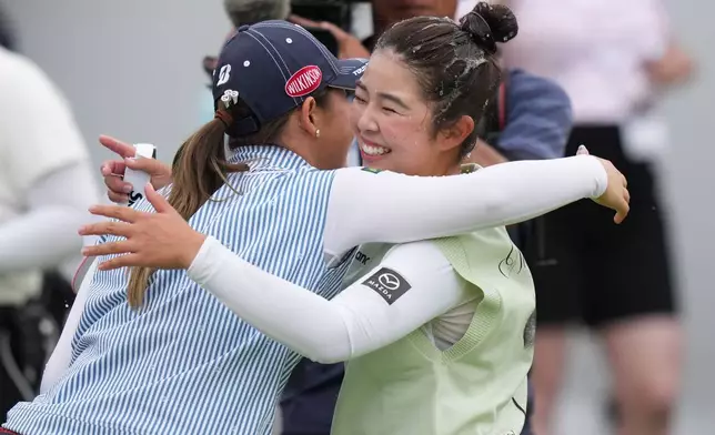 Miyu Yamashita, right, of Japan, celebrates with Yuri Yoshida, of Japan, after winning the LPGA Canadian Women's Open golf tournament in Edmonton, Alberta, Sunday, Aug. 23, 2026. (Darryl Dyck/The Canadian Press via AP)
