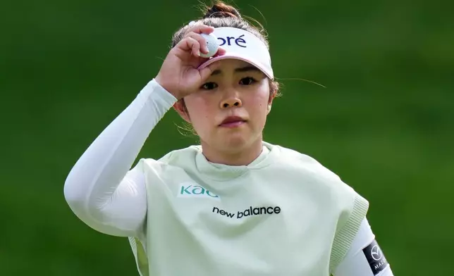 Miyu Yamashita, of Japan, tips her visor to the crowd after making par on the ninth hole during the final round at the LPGA Canadian Women's Open golf tournament in Edmonton, Alberta, Sunday, Aug. 23, 2026. (Darryl Dyck/The Canadian Press via AP)
